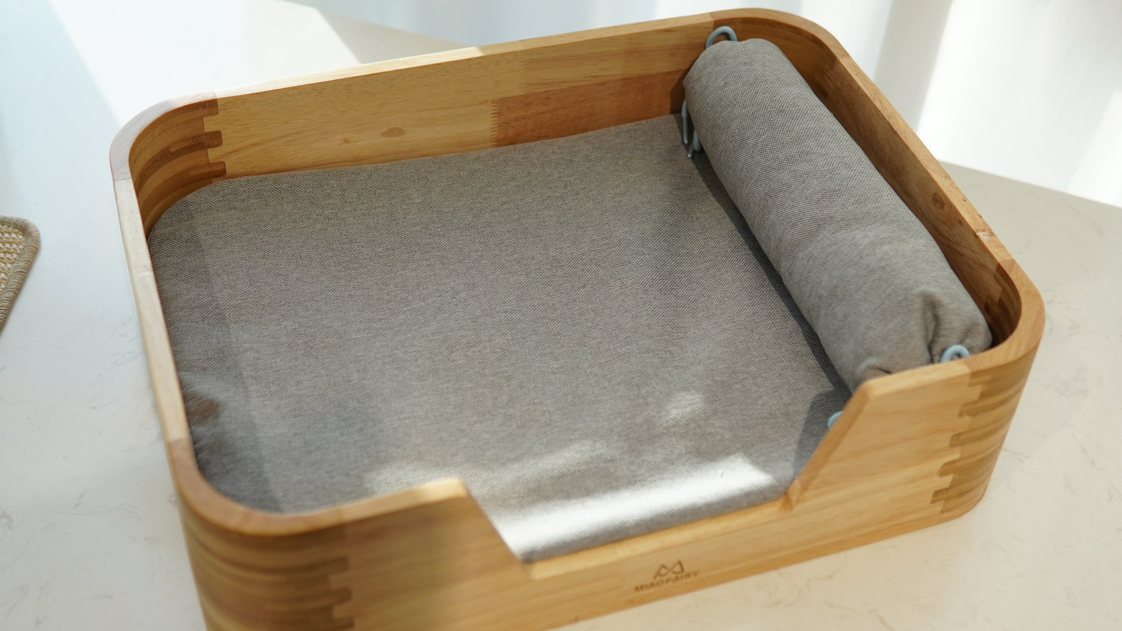 Bamboo Pet Bed - top-down view with grey cushion and bolster