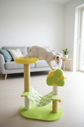 Green and yellow cat tree in a bright Scandinavian living room
